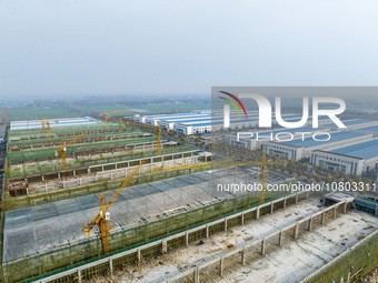 Workers are working at the construction site of a comprehensive utilization base for automobile recycling in Lianyungang, East China's Jiang...