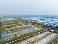 Workers are working at the construction site of a comprehensive utilization base for automobile recycling in Lianyungang, East China's Jiang...