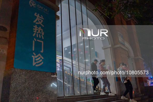 Parents with children who are suffering from respiratory diseases are lining up at a children's hospital in Chongqing, China, on November 23...