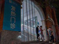 Parents with children who are suffering from respiratory diseases are lining up at a children's hospital in Chongqing, China, on November 23...