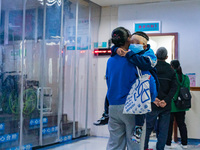 Parents with children who are suffering from respiratory diseases are lining up at a children's hospital in Chongqing, China, on November 23...