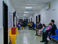 Parents with children who are suffering from respiratory diseases are lining up at a children's hospital in Chongqing, China, on November 23...