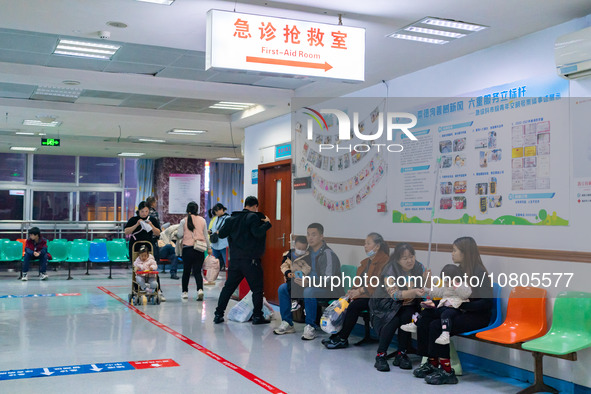 Parents with children who are suffering from respiratory diseases are lining up at a children's hospital in Chongqing, China, on November 23...