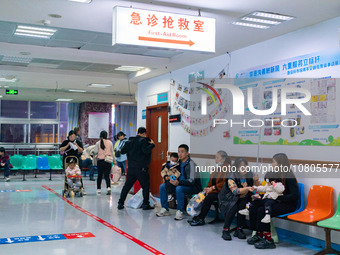 Parents with children who are suffering from respiratory diseases are lining up at a children's hospital in Chongqing, China, on November 23...