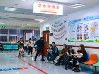 Parents with children who are suffering from respiratory diseases are lining up at a children's hospital in Chongqing, China, on November 23...