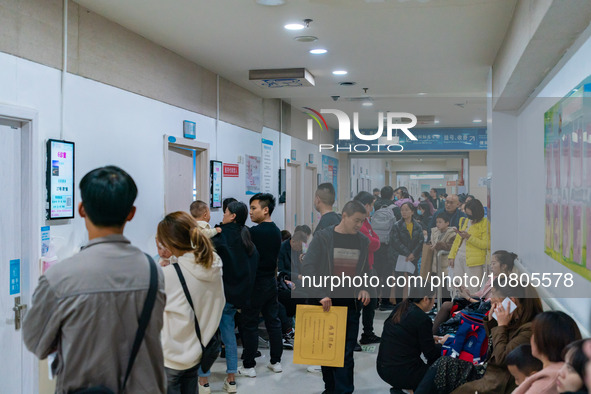 Parents with children who are suffering from respiratory diseases are lining up at a children's hospital in Chongqing, China, on November 23...