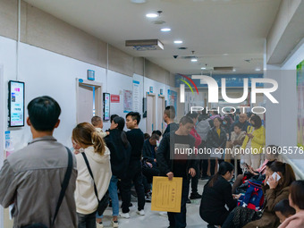 Parents with children who are suffering from respiratory diseases are lining up at a children's hospital in Chongqing, China, on November 23...