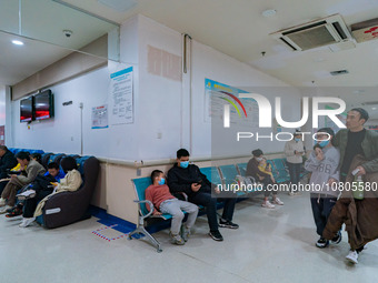 Parents with children who are suffering from respiratory diseases are lining up at a children's hospital in Chongqing, China, on November 23...