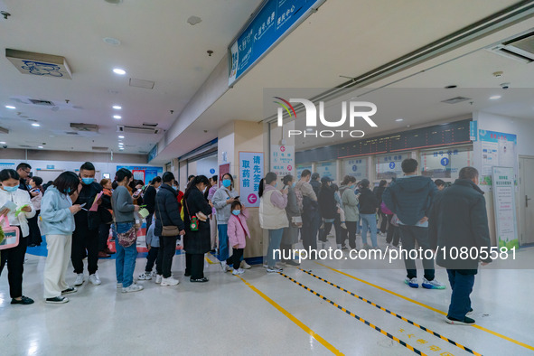 Parents with children who are suffering from respiratory diseases are lining up at a children's hospital in Chongqing, China, on November 23...