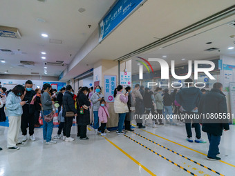 Parents with children who are suffering from respiratory diseases are lining up at a children's hospital in Chongqing, China, on November 23...