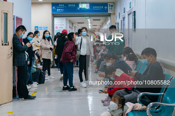 Parents with children who are suffering from respiratory diseases are lining up at a children's hospital in Chongqing, China, on November 23...