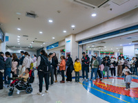 Parents with children who are suffering from respiratory diseases are lining up at a children's hospital in Chongqing, China, on November 23...