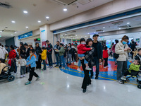 Parents with children who are suffering from respiratory diseases are lining up at a children's hospital in Chongqing, China, on November 23...