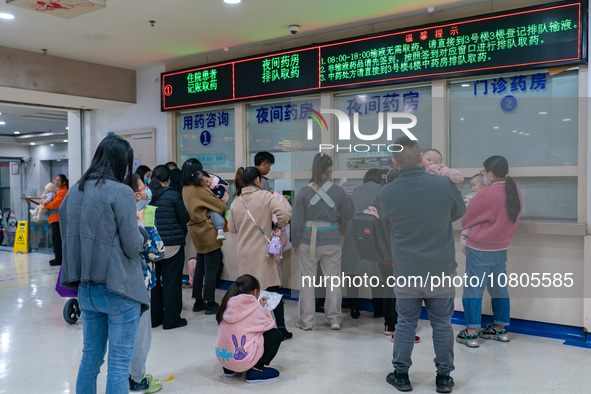 Parents with children who are suffering from respiratory diseases are lining up at a children's hospital in Chongqing, China, on November 23...