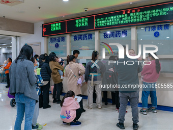 Parents with children who are suffering from respiratory diseases are lining up at a children's hospital in Chongqing, China, on November 23...