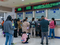 Parents with children who are suffering from respiratory diseases are lining up at a children's hospital in Chongqing, China, on November 23...