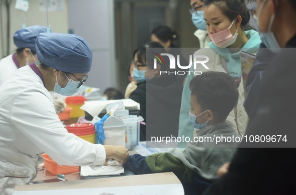 A nurse is preparing an infusion for a child in the infusion area of Hangzhou First People's Hospital in Hangzhou, Zhejiang province, China,...