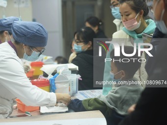 A nurse is preparing an infusion for a child in the infusion area of Hangzhou First People's Hospital in Hangzhou, Zhejiang province, China,...