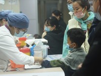 A nurse is preparing an infusion for a child in the infusion area of Hangzhou First People's Hospital in Hangzhou, Zhejiang province, China,...