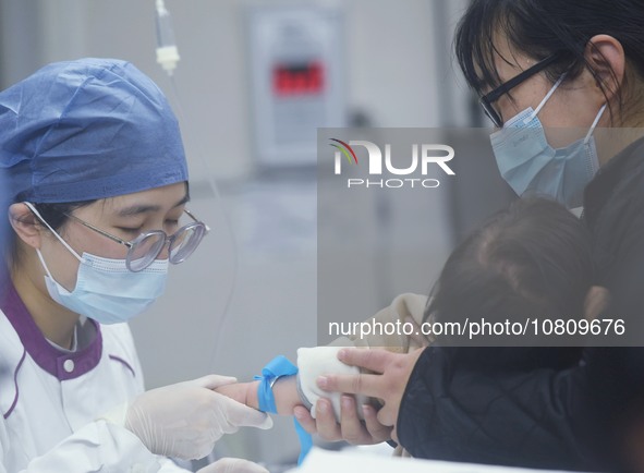 A nurse is preparing an infusion for a child in the infusion area of Hangzhou First People's Hospital in Hangzhou, Zhejiang province, China,...