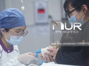 A nurse is preparing an infusion for a child in the infusion area of Hangzhou First People's Hospital in Hangzhou, Zhejiang province, China,...