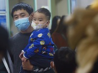 A nurse is preparing an infusion for a child in the infusion area of Hangzhou First People's Hospital in Hangzhou, Zhejiang province, China,...