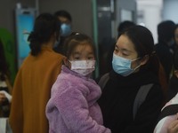 A nurse is preparing an infusion for a child in the infusion area of Hangzhou First People's Hospital in Hangzhou, Zhejiang province, China,...