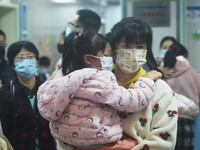 A nurse is preparing an infusion for a child in the infusion area of Hangzhou First People's Hospital in Hangzhou, Zhejiang province, China,...