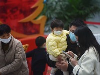 A nurse is preparing an infusion for a child in the infusion area of Hangzhou First People's Hospital in Hangzhou, Zhejiang province, China,...