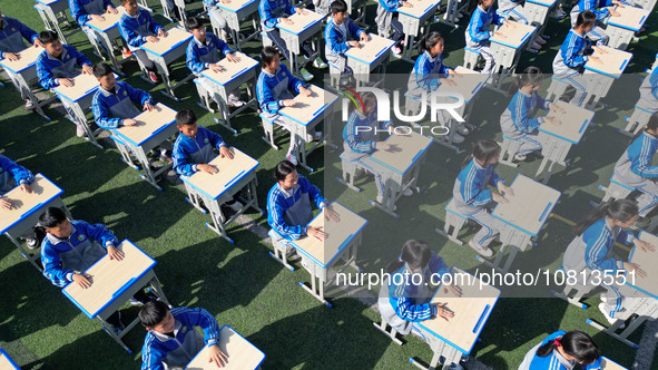 Students are performing desk exercises at the Third Nationalities Middle School in Congjiang County, Guizhou Province, southwest China, on N...