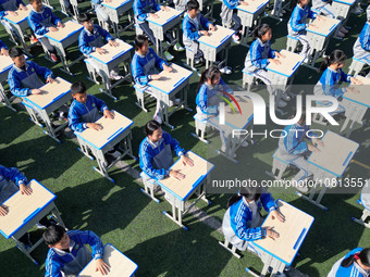 Students are performing desk exercises at the Third Nationalities Middle School in Congjiang County, Guizhou Province, southwest China, on N...