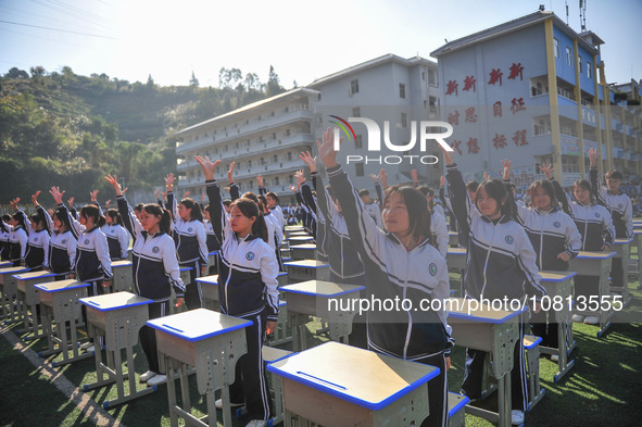 Students are performing desk exercises at the Third Nationalities Middle School in Congjiang County, Guizhou Province, southwest China, on N...