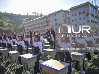 Students are performing desk exercises at the Third Nationalities Middle School in Congjiang County, Guizhou Province, southwest China, on N...