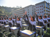 Students are performing desk exercises at the Third Nationalities Middle School in Congjiang County, Guizhou Province, southwest China, on N...