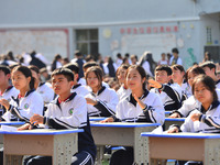 Students are performing desk exercises at the Third Nationalities Middle School in Congjiang County, Guizhou Province, southwest China, on N...