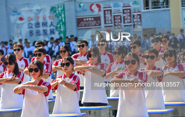 Students are performing desk exercises at the Third Nationalities Middle School in Congjiang County, Guizhou Province, southwest China, on N...