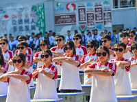 Students are performing desk exercises at the Third Nationalities Middle School in Congjiang County, Guizhou Province, southwest China, on N...