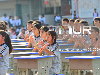 Students are performing desk exercises at the Third Nationalities Middle School in Congjiang County, Guizhou Province, southwest China, on N...