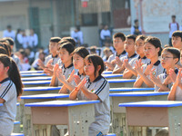 Students are performing desk exercises at the Third Nationalities Middle School in Congjiang County, Guizhou Province, southwest China, on N...