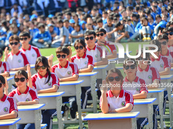 Students are performing desk exercises at the Third Nationalities Middle School in Congjiang County, Guizhou Province, southwest China, on N...