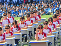 Students are performing desk exercises at the Third Nationalities Middle School in Congjiang County, Guizhou Province, southwest China, on N...