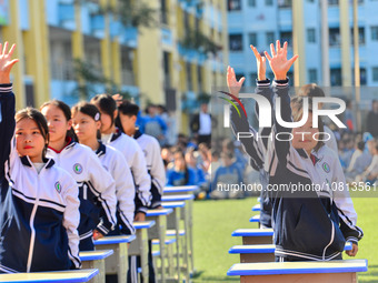 Students are performing desk exercises at the Third Nationalities Middle School in Congjiang County, Guizhou Province, southwest China, on N...