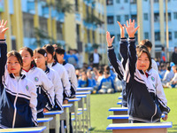 Students are performing desk exercises at the Third Nationalities Middle School in Congjiang County, Guizhou Province, southwest China, on N...