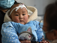 A 7-month-old baby is receiving infusion treatment at the Department of Pediatrics of the People's Hospital in Fuyang, Anhui province, China...