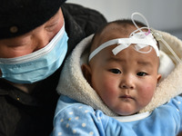 A 7-month-old baby is receiving infusion treatment at the Department of Pediatrics of the People's Hospital in Fuyang, Anhui province, China...