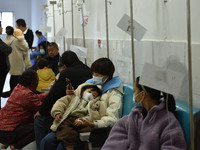 Sick children, accompanied by their parents, are receiving infusion treatment at the Department of Pediatrics of the People's Hospital in Fu...