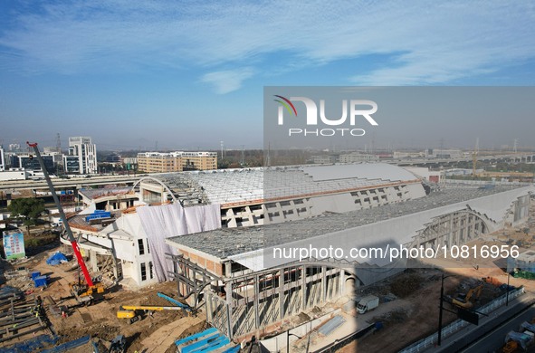 Workers are installing the facade of the experimental building for Zhejiang University's High gravity centrifugal simulation and experimenta...