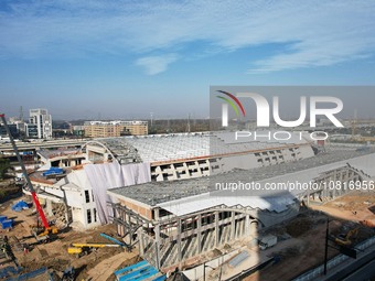 Workers are installing the facade of the experimental building for Zhejiang University's High gravity centrifugal simulation and experimenta...