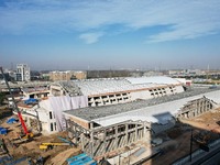 Workers are installing the facade of the experimental building for Zhejiang University's High gravity centrifugal simulation and experimenta...