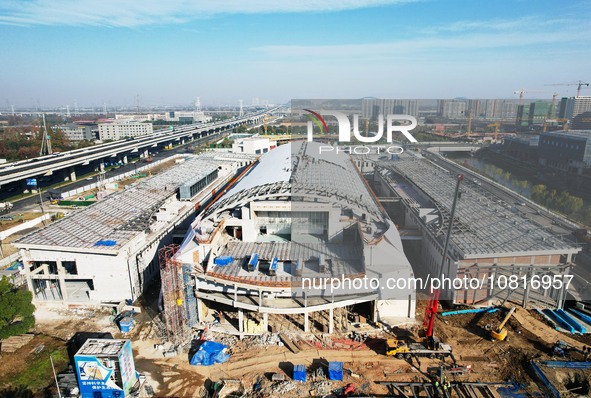 Workers are installing the facade of the experimental building for Zhejiang University's High gravity centrifugal simulation and experimenta...